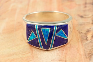 Genuine  Blue Lapis inlaid between ribbons of Sterling Silver. Beautiful Fire and Ice Lab Opal Accents. Stunning Ring Designed by Navajo Artist Calvin Begay. Signed.